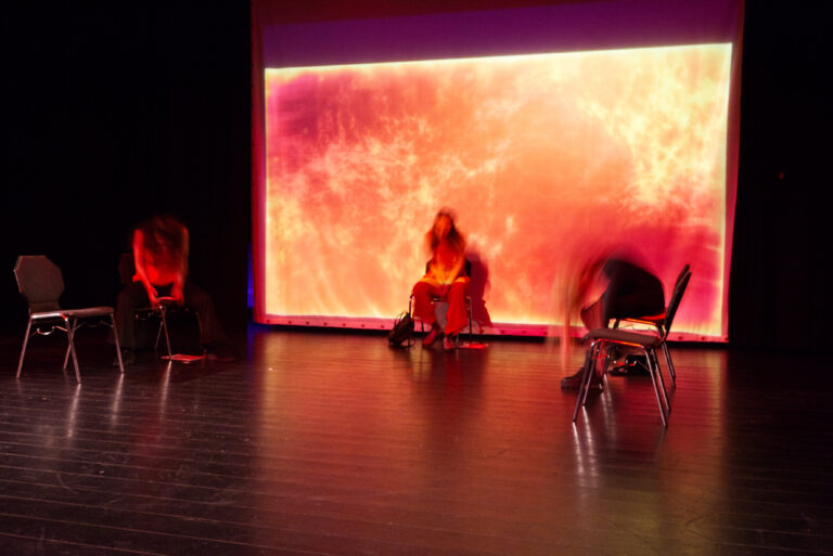 Actresses dance on chairs.