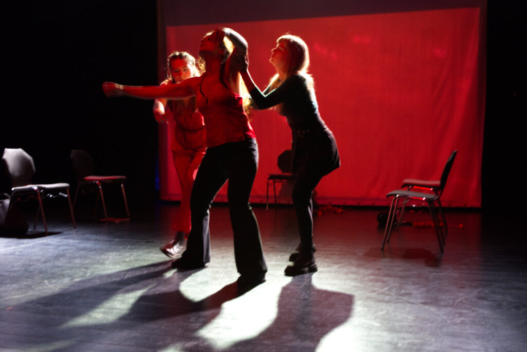 Three actresses interact  and dance